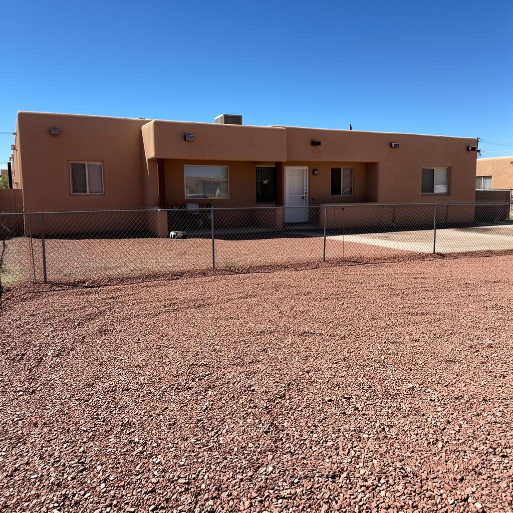 Same Rio Rancho yard cleared and raked after cleanup